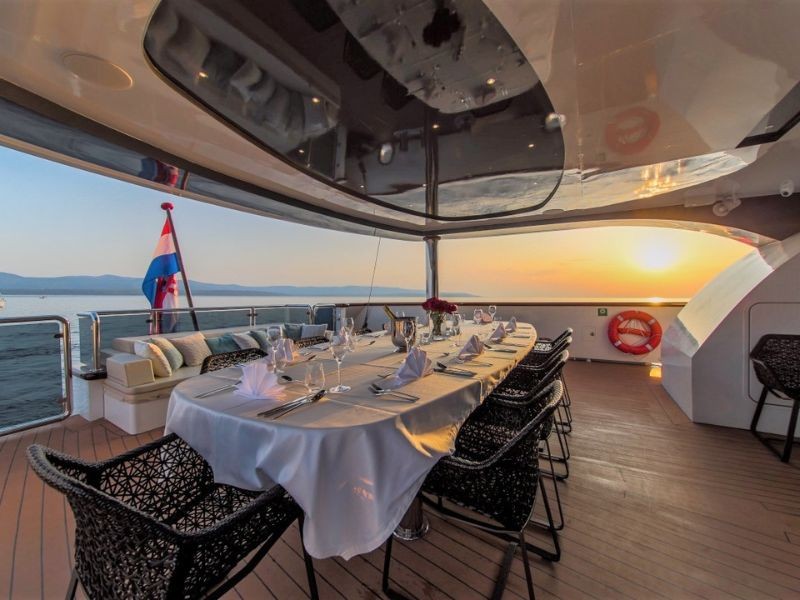 MSY Omnia main deck's stern dining area overlooking the sunset