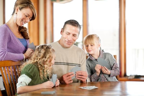 Family enjoying playing a game with cards