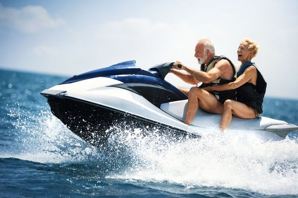 Man and woman enjoying riding a jet ski