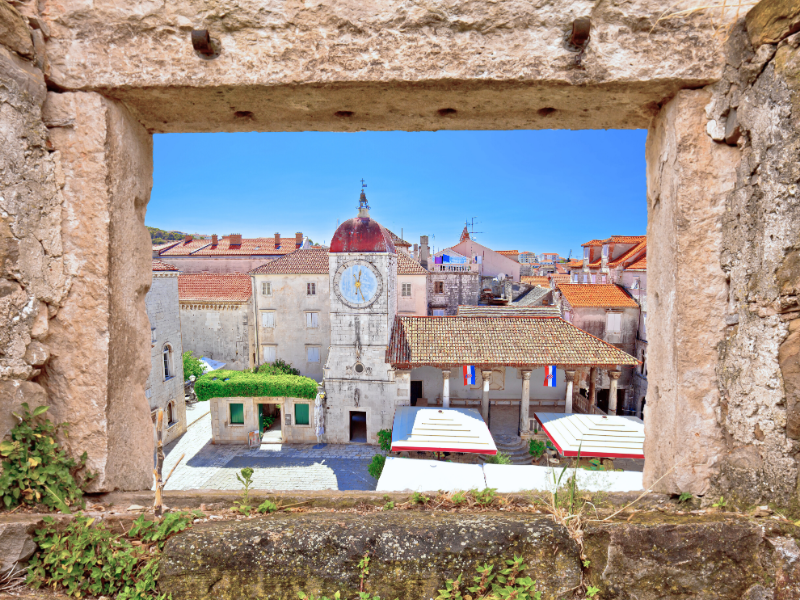 UNESCO Town of Trogir main square view through a stone window