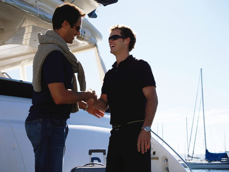 Deckhand welcoming the guest onboard a yacht